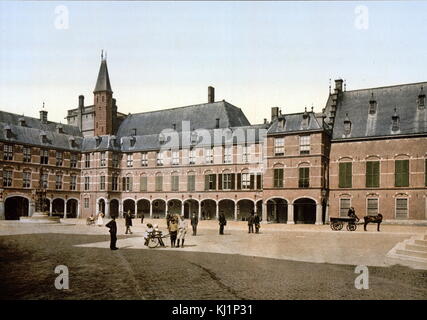 photomechanical print dated to 1900, depicting the Binnenhof (Inner Court) buildings in the city centre of The Hague, next to the Hofvijver lake. It houses the meeting place of both houses of the States General of the Netherlands, as well as the Ministry of General Affairs and the office of the Prime Minister of the Netherlands. Built primarily in the 13th century, the Gothic castle originally functioned as residence of the counts of Holland and became the political centre of the Dutch Republic in 1584. Stock Photo