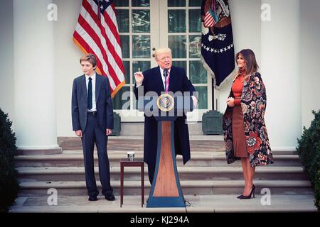 Washington, United States Of America. 21st Nov, 2017. U.S. President Donald Trump, center, delivers remarks at the traditional National Thanksgiving Turkey Pardoning ceremony as Barron Trump, left, and and First Lady Melania Trump, right, look on in the Rose Garden of the White House November 21, 2017 in Washington, DC Credit: Planetpix/Alamy Live News Stock Photo