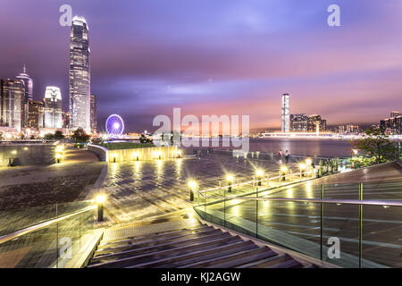 Stunning night view of the famous Hong Kong island Central business district skyline from the park along the Victoria harbor with Kowloon on the other Stock Photo