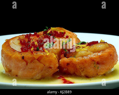 Salmon wrapped scallops with beurre blanc and caviar Stock Photo