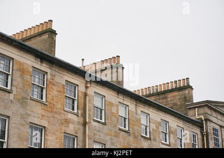 Rows of chimneys on typical sandstone tenement buildings in UK Stock Photo