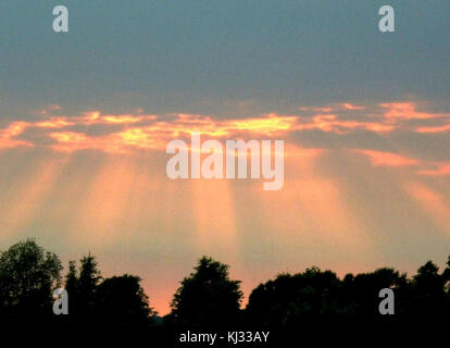 This natural phenomenon captures the beauty of sunlight breaking through clouds, often seen as a dramatic and awe-inspiring sight, highlighting nature's power and visual appeal. Stock Photo
