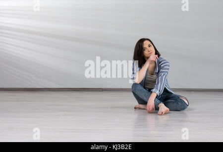 Young female dancer on studio background. Stock Photo