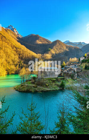 Isola Santa medieval village, church, lake and Alpi Apuane mountains. Garfagnana, Tuscany, Italy Europe Stock Photo