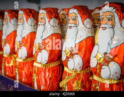 Zurich, Switzerland - 17 Nov 2017: Less than 6 weeks before Christmas, an army of chocolate Santa Clauses is lined up on a supermarket shelf. Stock Photo