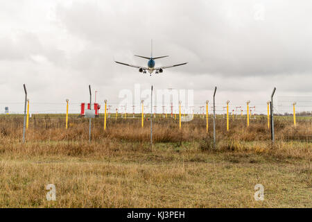 Landing of a large civil aircraft over the landing lights of the airfield, rear view Stock Photo