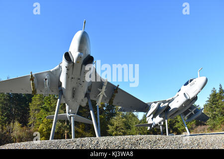 Two Navy fighter jets with bombs underneath welcome visitors to Oak Harbor on Whidbey Island in Washington State. Stock Photo