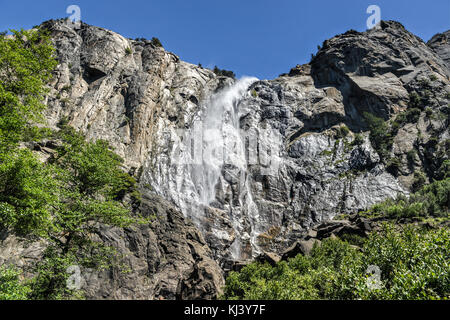 Bridalveil Falls as it is blown in the wind in Yosemite National Park. It is one of the most prominent waterfalls in the Yosemite Valley in California Stock Photo