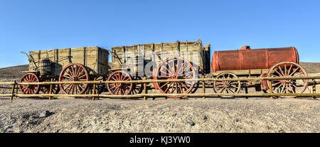 Old wagons and water tank at the Harmony Borax Works where 20 Mule Teams hauled the borax out of Death Valley in the 1880's. Stock Photo