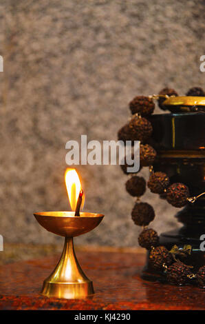 Close-up of Diya or a traditional small brass lamp, lit using oil and cotton thread or cotton part of Aarti. Patit Pavan Sri Ram Mandir, Belgavi, Karn Stock Photo