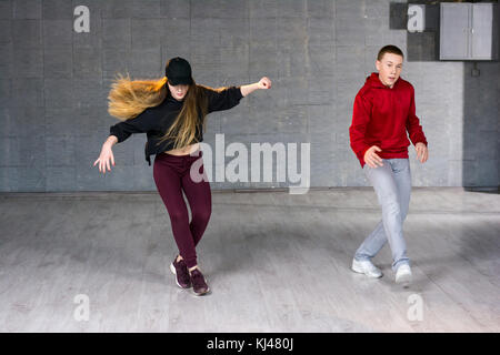 Couple of hip-hop dancers is dancing. Stock Photo