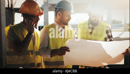 Portrait of construction engineers working on building site Stock Photo