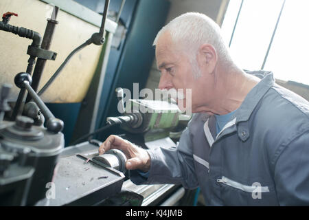 milling-machine operator works at machine Stock Photo