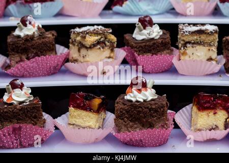 Sweet bridal buffet with cakes and muffins stacked in a pyramid- delicious cakes: chocolate and jelly Stock Photo