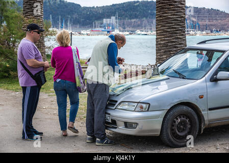 Man selling cherries on a beach promenade in Bar coastal town in southern Montenegro Stock Photo