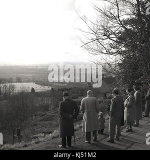 1950s, historical, men and women taking in the view over the countryside on a family group outing or walk, England, UK. Stock Photo