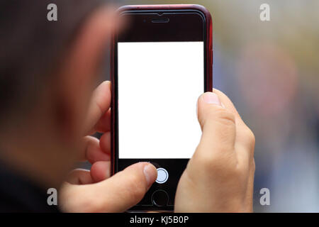 Smartphone blank screen template with copy space in man's hands. Blurred background Stock Photo