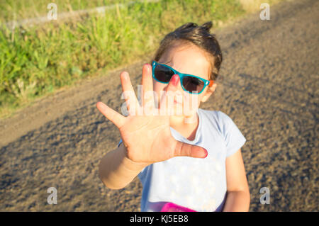 5 years old little girl show her hand full of mulberry stain juice. Closeup Stock Photo