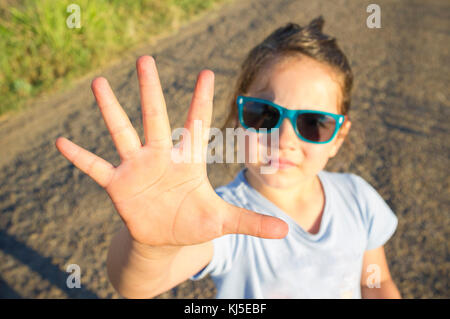 5 years old little girl shows five fingers. Closeup Stock Photo