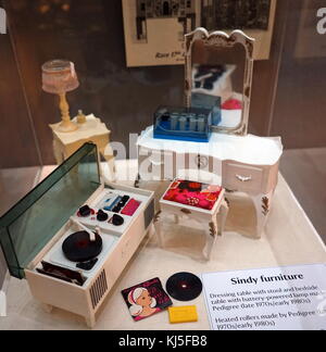 Collection of furniture made for Sindy Dolls. Included is a dressing table with stool, bedside table with battery-powered lamp, heated rollers for hair, a record player and record. Dated 20th Century Stock Photo