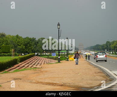 View from Rajpath Marg to India Gate, Delhi India. Rajpath (meaning 'King's Way') is a ceremonial boulevard in New Delhi, India, that runs from Rashtrapati Bhavan on Raisina Hill through Vijay Chowk and India Gate to the National Stadium. The avenue is lined on both sides by huge lawns, canals and rows of trees. It was designed by Edward Lutyens Stock Photo