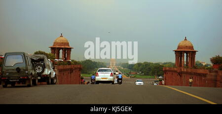 View from Rajpath Marg to India Gate, Delhi India. Rajpath (meaning 'King's Way') is a ceremonial boulevard in New Delhi, India, that runs from Rashtrapati Bhavan on Raisina Hill through Vijay Chowk and India Gate to the National Stadium. The avenue is lined on both sides by huge lawns, canals and rows of trees. It was designed by Edward Lutyens Stock Photo