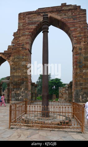 The Iron Pillar located in the Qutb complex (monuments and buildings), at Mehrauli in Delhi, India. It is a 7 m (23 ft) column, in the Qutb complex, notable for the rust-resistant composition of the metals used in its construction. The pillar weighs over 6,000 kg (13,000 lb), and is thought to have originally been erected in what is now Udayagiri by one of the Gupta monarchs in approximately 402 CE Stock Photo