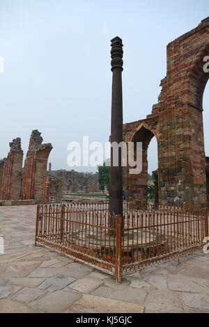 The Iron Pillar located in the Qutb complex (monuments and buildings), at Mehrauli in Delhi, India. It is a 7 m (23 ft) column, in the Qutb complex, notable for the rust-resistant composition of the metals used in its construction. The pillar weighs over 6,000 kg (13,000 lb), and is thought to have originally been erected in what is now Udayagiri by one of the Gupta monarchs in approximately 402 CE Stock Photo