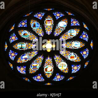 Stained glass Rose Window inside the St. Pierre Cathedral, in Geneva, Switzerland. The Cathedral belongs to the Reformed Protestant Church of Geneva. It is known as the adopted home church of John Calvin, one of the leaders of the Protestant Reformation. Stock Photo