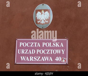 Street sign in the Old town, Warsaw, Poland with the Polish eagle crest above Stock Photo