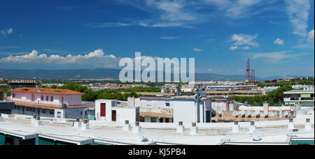 Salou, Spain - August 13, 2017: Salou is one of the largest tourist cities in Spain.Above the roofs are the slides of the entertainment parks of Port  Stock Photo