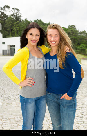 Two happy and beautiful teenage students in the school Stock Photo