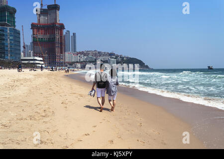 Korean couple walking on Haeundae Beach Stock Photo