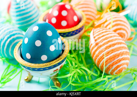 Creative and decorative Easter eggs.Selective focus on the left blue egg Stock Photo