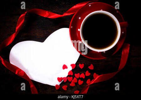 Cup of dark coffee and blank Valentine heart shape card Stock Photo