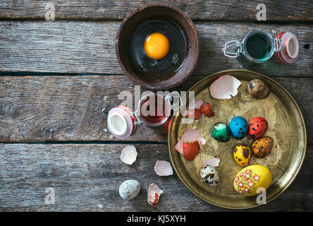 Easter decorative eggs in the plate on wooden background with blank space Stock Photo