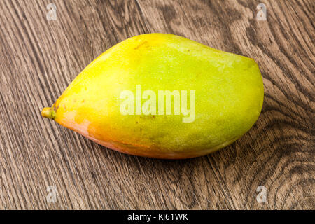 Sweet mango fruit over the wooden background Stock Photo