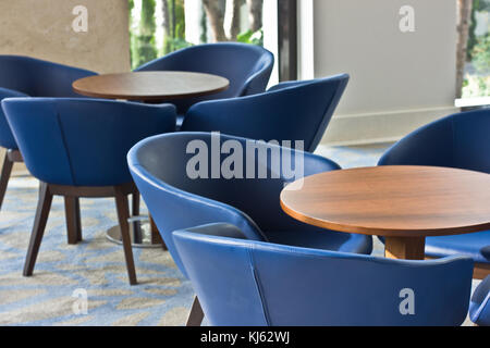 Interior. Blue leather chairs and a brown wooden table. Stock Photo