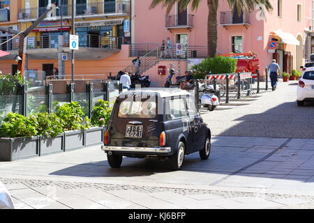 An old timer small fiat 500 car in the italian city center. Stock Photo