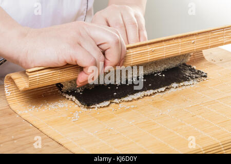 Japanese chef. Chef prepares rolls, hands closeup Stock Photo