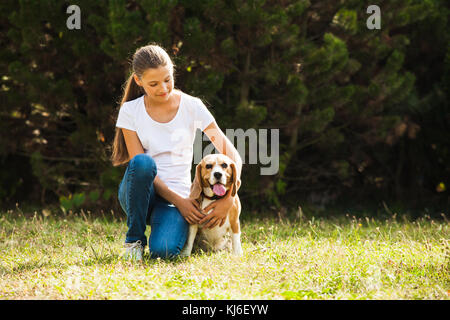 Girl plays with a dog Stock Photo