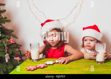 Two girls near Christmas tree Stock Photo