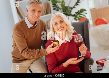 Radiant husband and wife getting excited over their anniversary Stock Photo