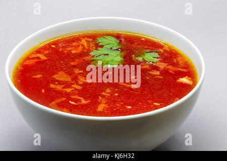 Borscht, Russian beet soup, in a white bowl. Stock Photo