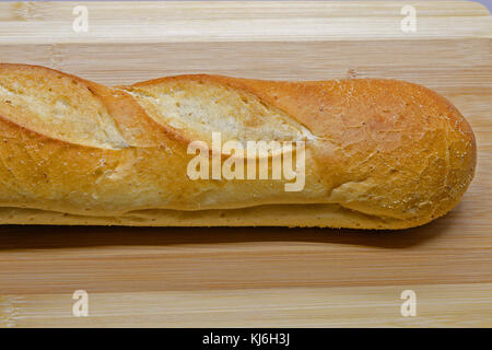 Loaf of bread on a cutting board. Stock Photo
