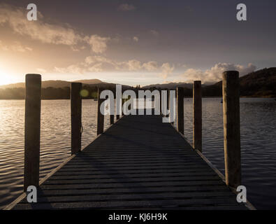 Sunset on a Wooden Jetty at Waterhead Pier on Lake Windermere near Ambleside, Cumbria Lake District England UK Stock Photo