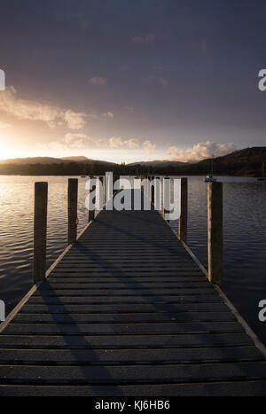 Sunset on a Wooden Jetty at Waterhead Pier on Lake Windermere near Ambleside, Cumbria Lake District England UK Stock Photo