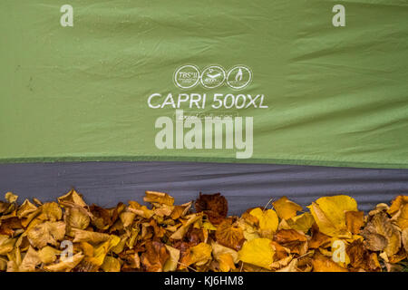 Autumn camping. Autumn leaves lie alongside a Vango Capri 500XL tent illustrating that camping other than in the summer is fun too. Stock Photo