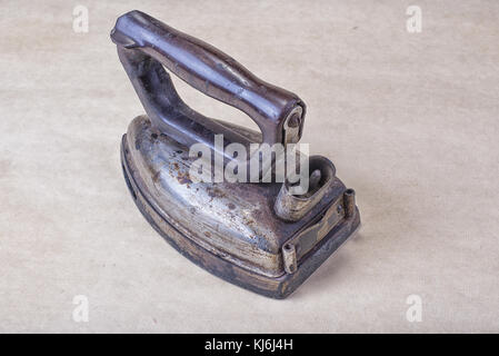Old classic electric iron burned out from sixties. Stock Photo