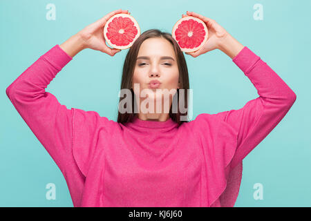 Pretty woman with delicious grapefruit in her arms. Stock Photo